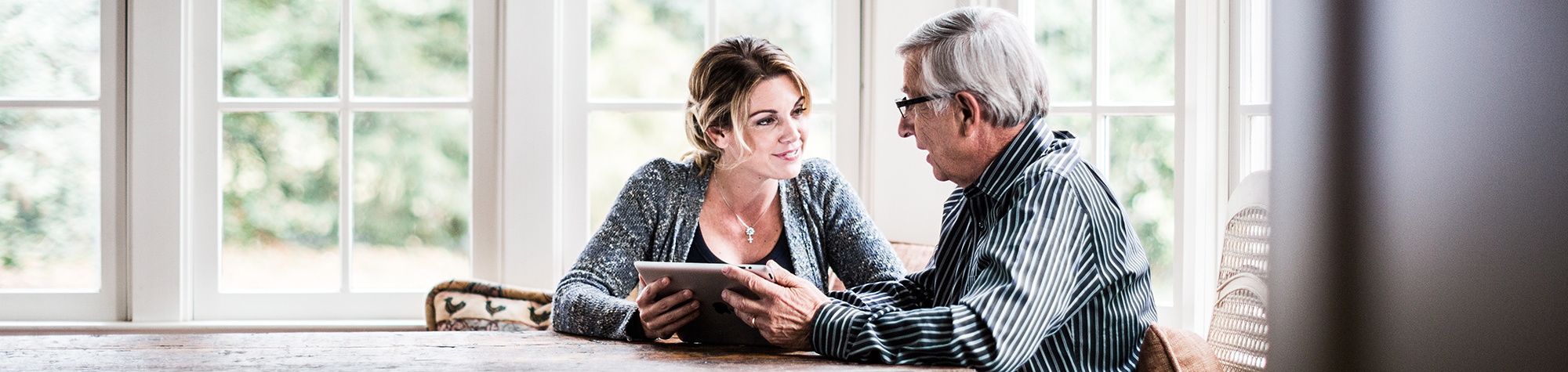 Daughter talking to her aging father about retirement