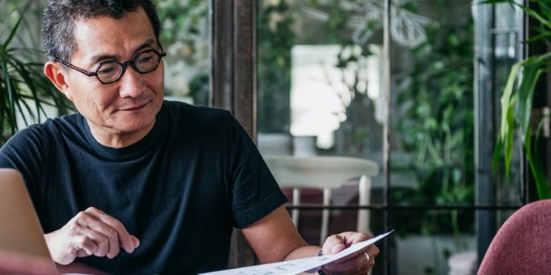 Asian man speaking with a financial advisor