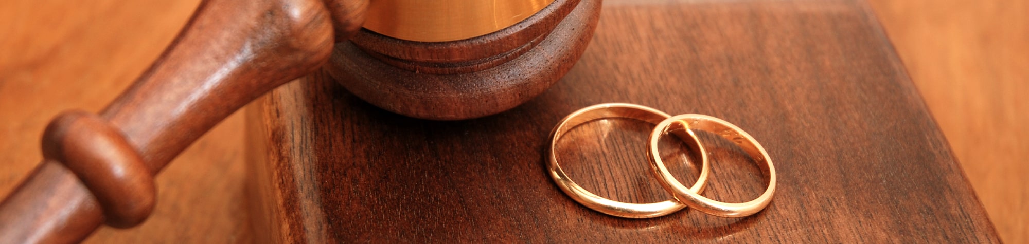 Two wedding bands next to a court gavel